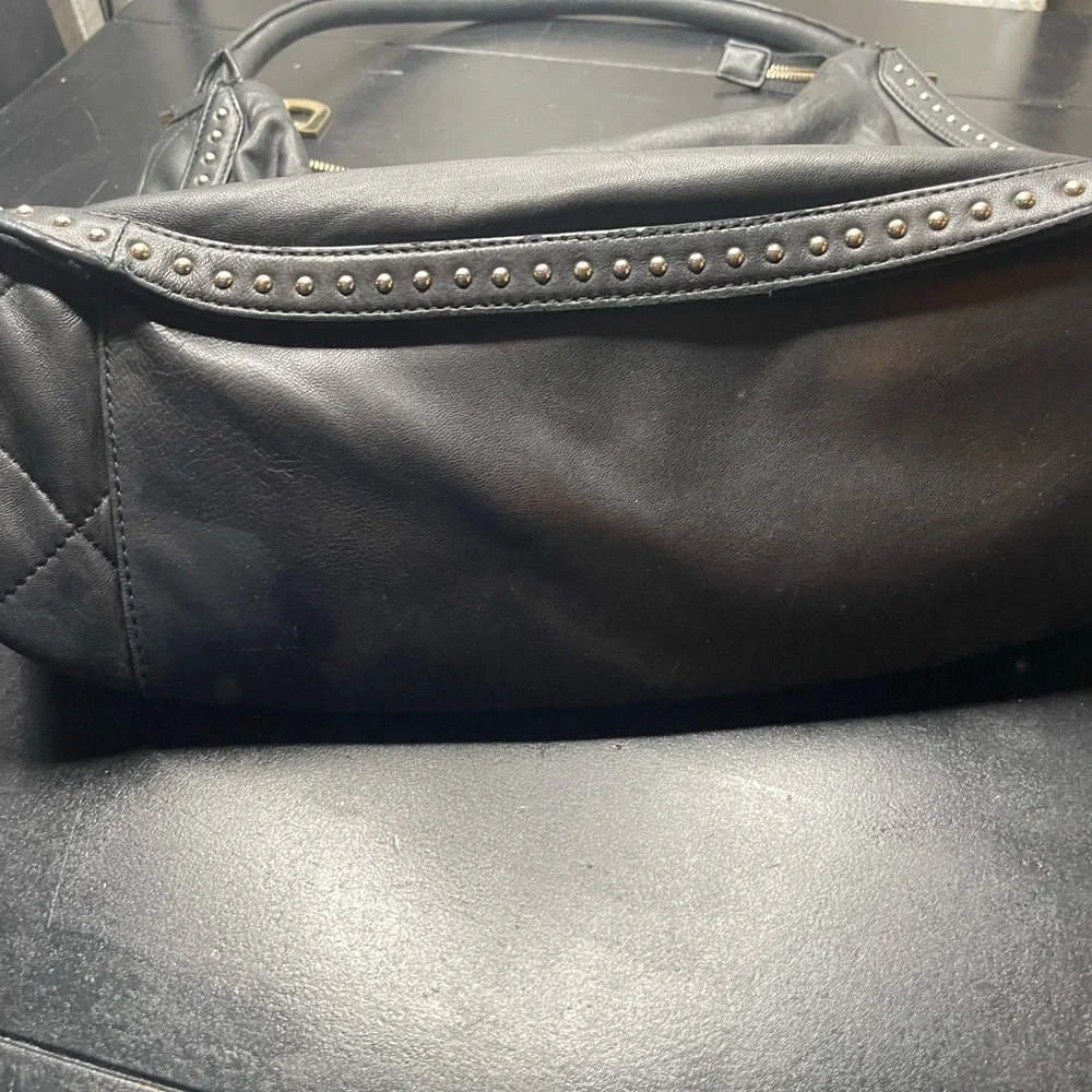 DKNY black leather shoulder bag with stud detailing.